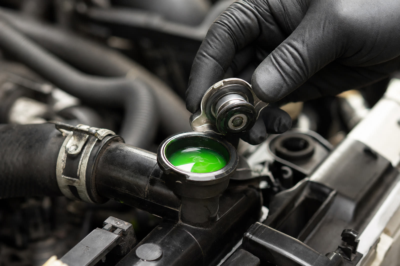 Perry's Quality Auto mechanic performing a coolant flush and radiator service in Simi Valley