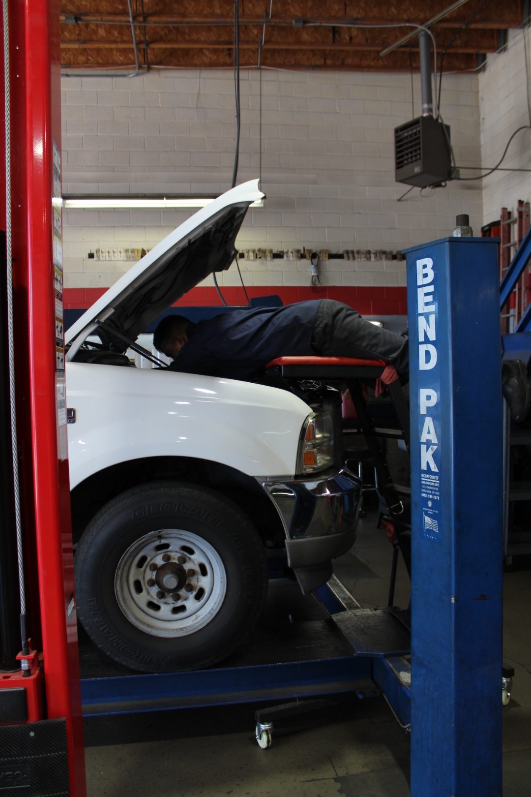 White Ford F-Series fleet truck on the BendPak two-post lift at Perry's Quality Auto