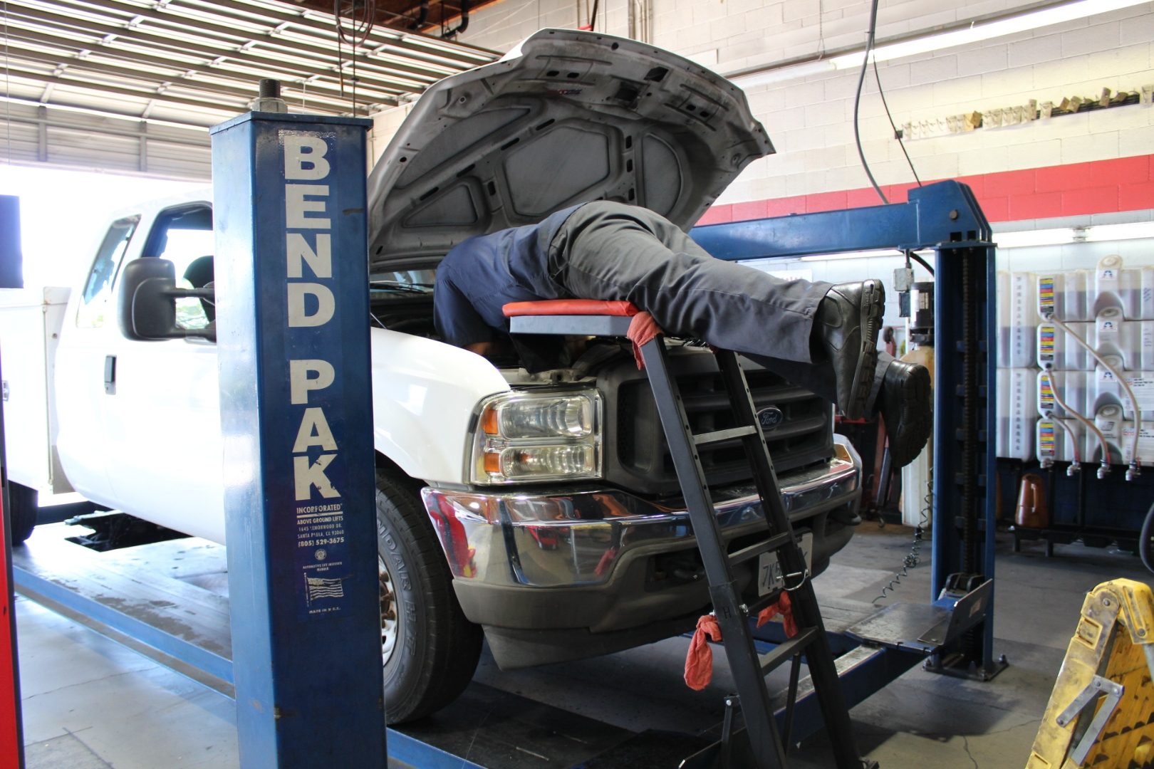 Perry's technician servicing a Ford Super Duty truck on the BendPak lift in Simi Valley